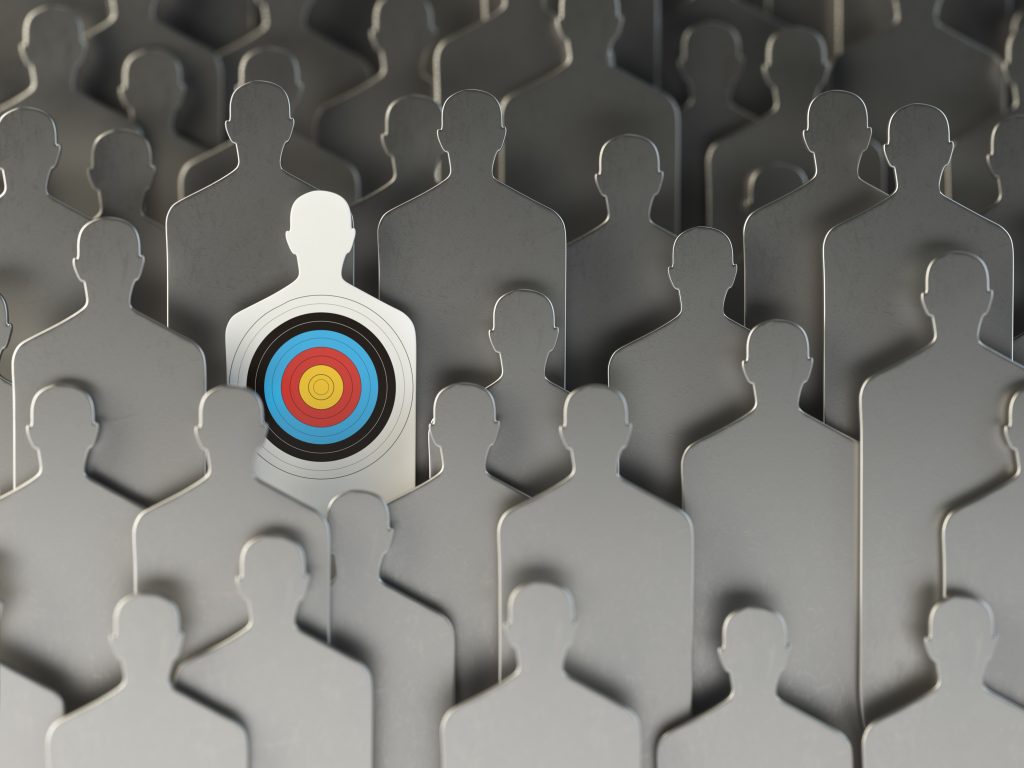 Set of gray shooting range targets with one white target highlighted, symbolizing precise targeting in outreach campaigns.